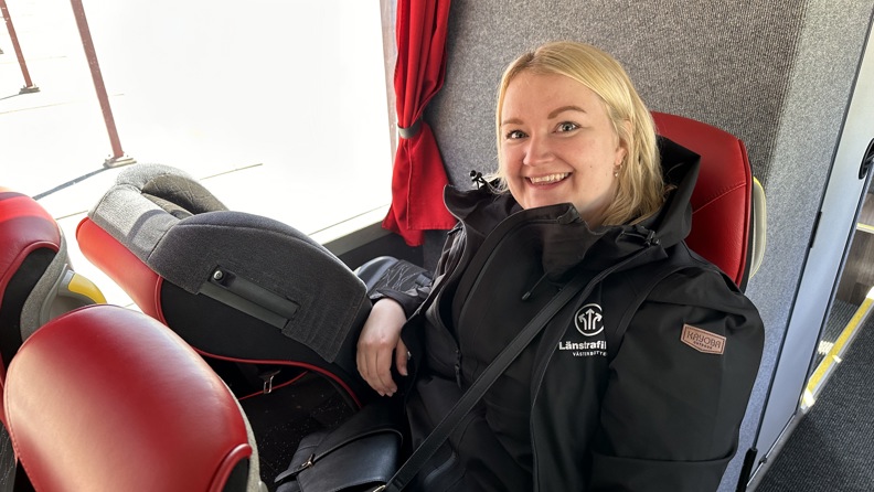 A passenger sitting next to a seat with SitSafe child seat