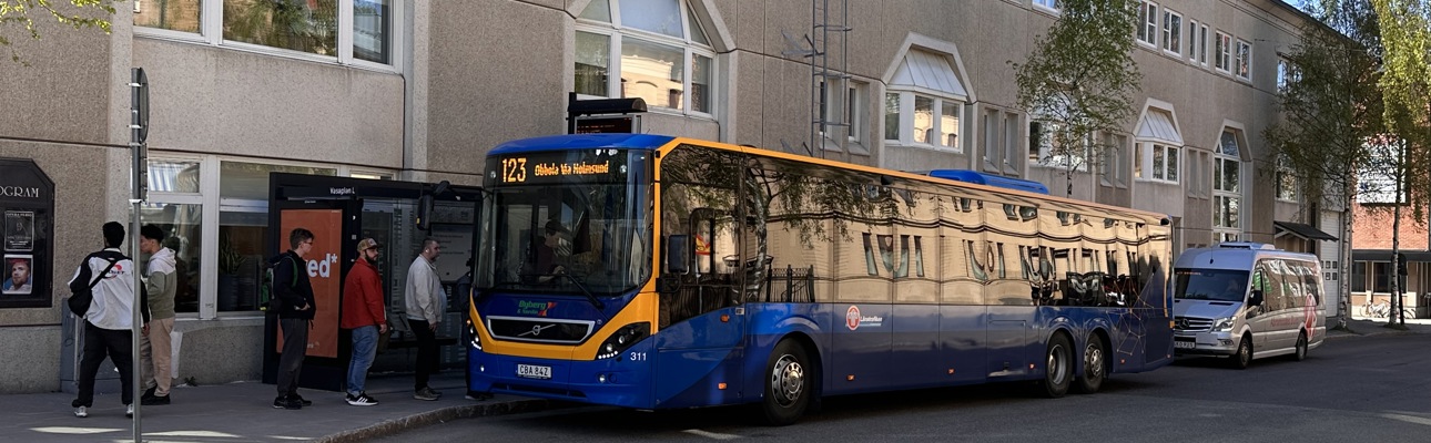 Bus stop with a bus and people