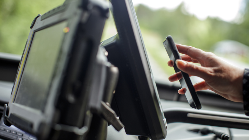 A mobile phone being held up to the ticket machine to validate a ticket